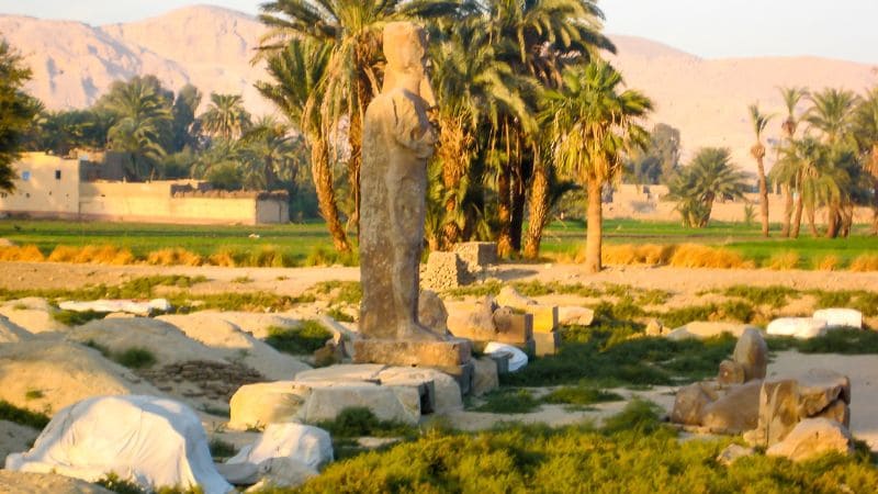 A solitary statue stands amid ruins at the Luxor Temple in Egypt.