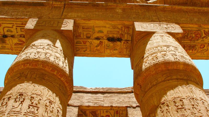 "Close-up of hieroglyphs on the massive columns at an Egyptian temple."