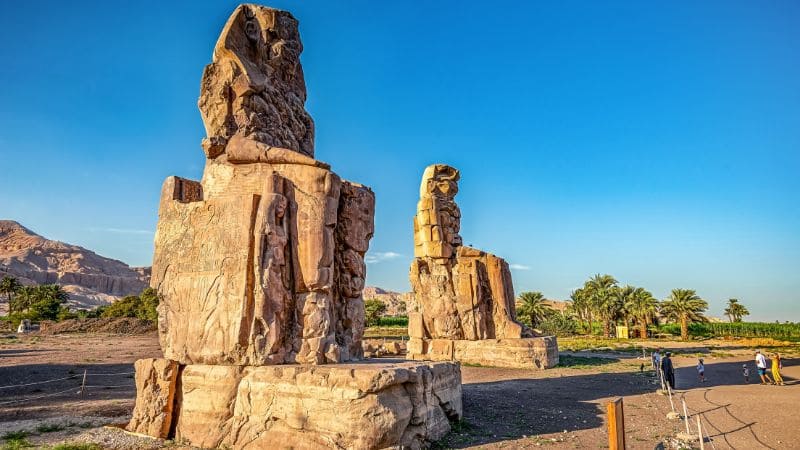 The Colossi of Memnon, two massive stone statues in the Theban necropolis.