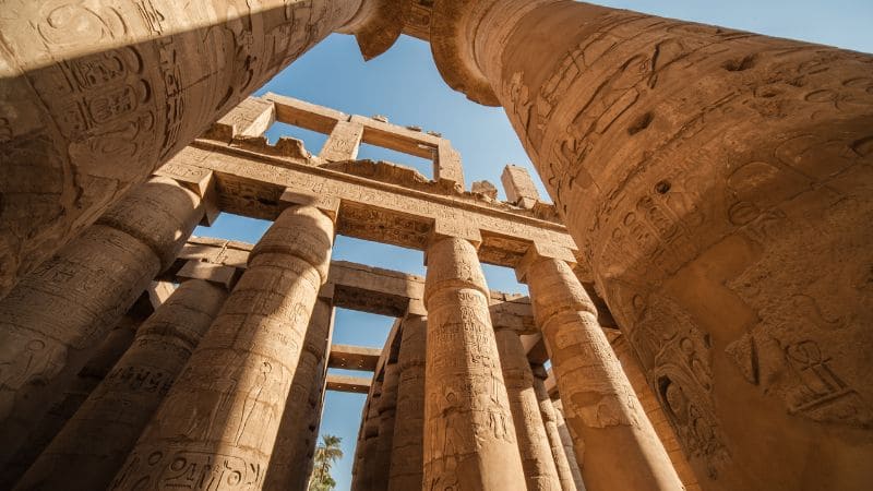 Looking up at towering columns in an ancient Egyptian temple.