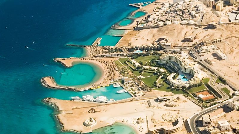 Aerial view of a coastal resort area with clear turquoise waters.