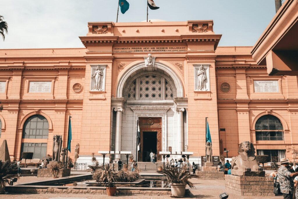 Exterior view of the Egyptian Museum in Cairo with its distinct pink façade and grand entrance