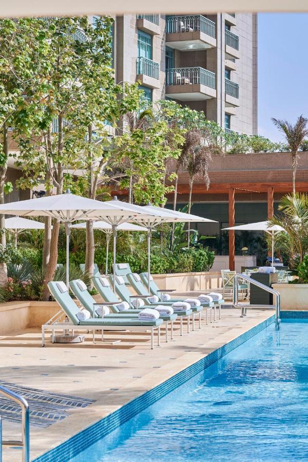 Four Seasons Hotel Cairo with a luxurious pool area and lush garden surroundings