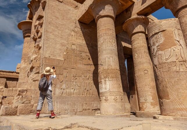 Luxor Temple illuminated at night, highlighting its grand columns and ancient statues.