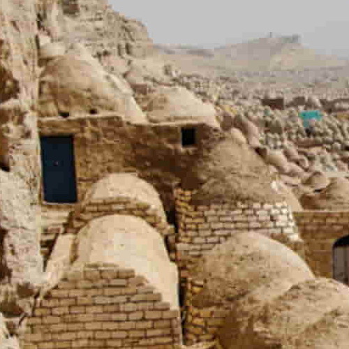 Cluster of traditional adobe houses built into a hillside