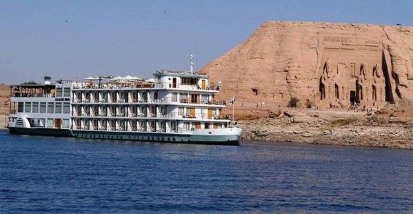 MS Kasr Ibrim cruise ship, a luxurious vessel with classic design and panoramic decks, sailing on the tranquil waters of Lake Nasser