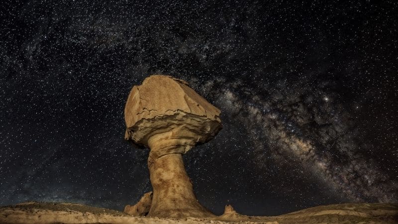 Starry night sky over the White Desert's unique white rock formations in Egypt