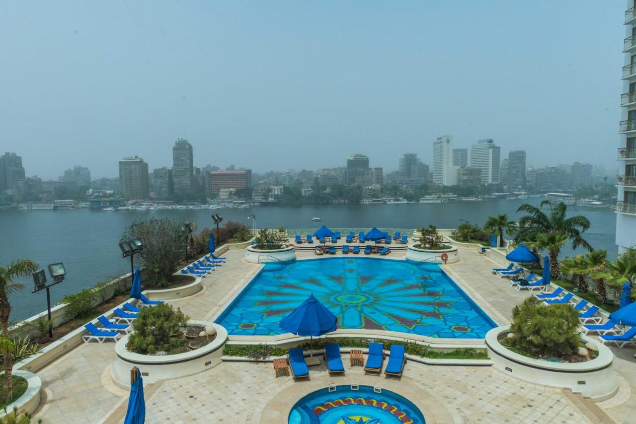 Luxurious hotel room with large windows offering views of the Nile River
