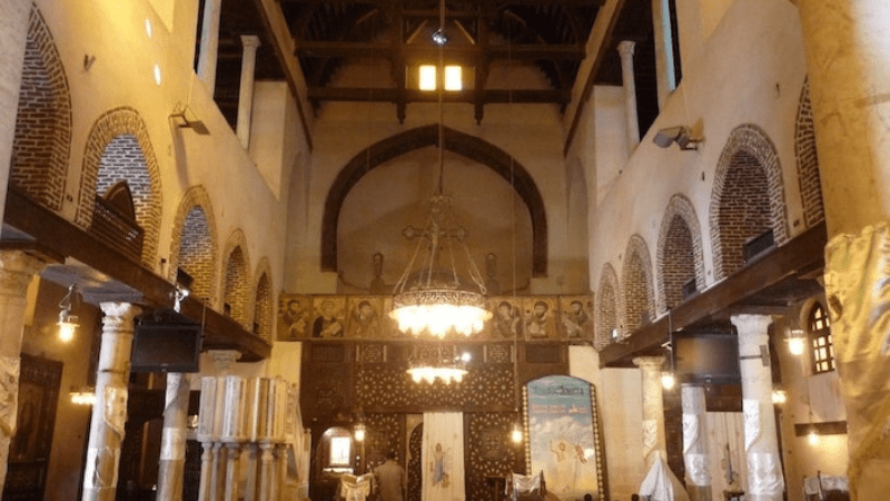 Interior of a church with hanging chandeliers and arches