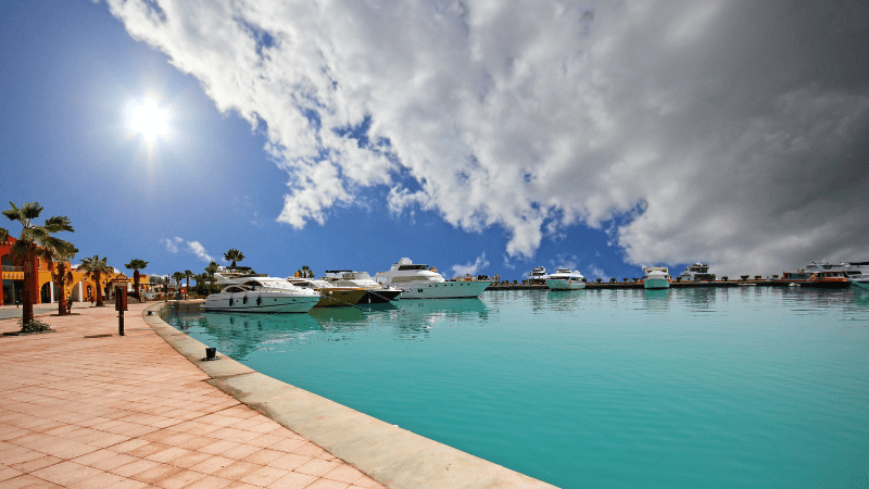 Marina with yachts against a dramatic sky.