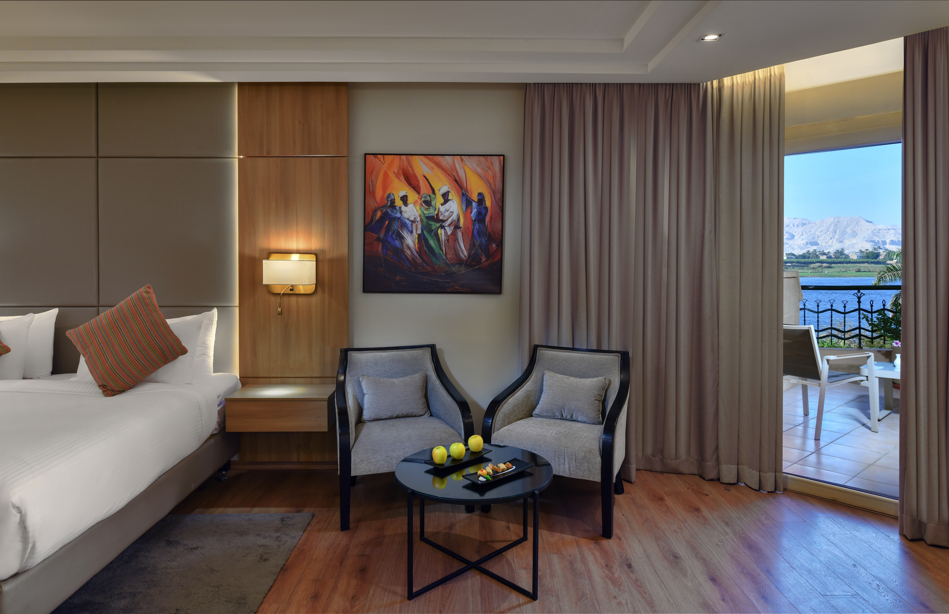 Family room with modern decor, two beds, and a seating area