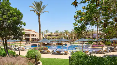 Luxurious outdoor pool area at The Westin Cairo Golf Resort & Spa with palm trees and lounge chairs